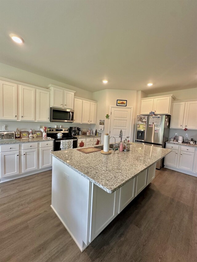 63 Windsor Way, Crawfordville, FL 32327 - kitchen featuring stainless steel appliances, white cabinetry, recessed lighting, dark wood-style flooring, and a center island with sink