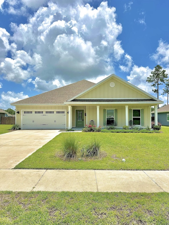 63 Windsor Way, Crawfordville, FL 32327 - view of front facade featuring a garage, concrete driveway, a porch, and board and batten siding