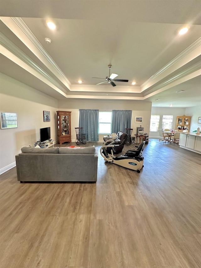 63 Windsor Way, Crawfordville, FL 32327 - living room featuring a raised ceiling, ornamental molding, healthy amount of natural light, wood finished floors, and recessed lighting