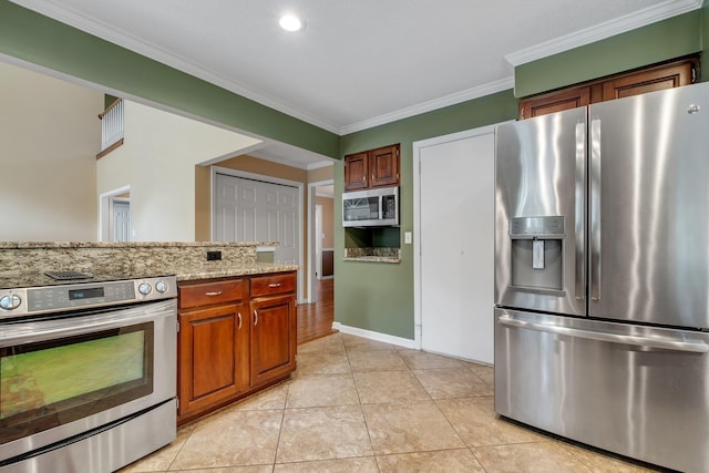 kitchen featuring brown cabinetry, crown molding, light stone countertops, light tile patterned floors, and stainless steel appliances