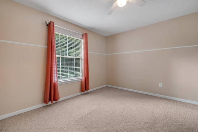 empty room with baseboards, carpet, and a ceiling fan