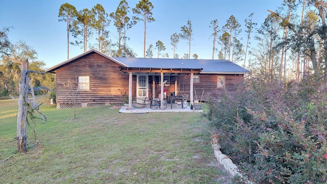 rear view of house featuring a patio and a yard