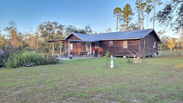 back of property with a patio and a yard