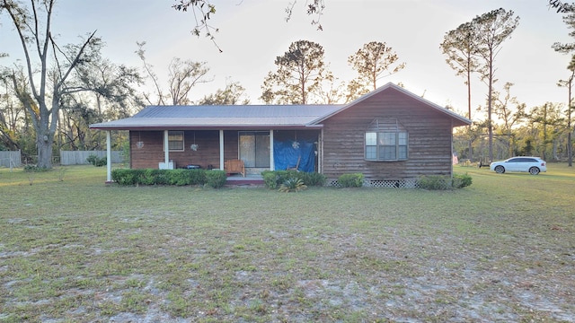 single story home featuring a front yard and covered porch