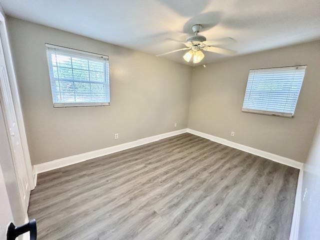 spare room with hardwood / wood-style flooring and ceiling fan