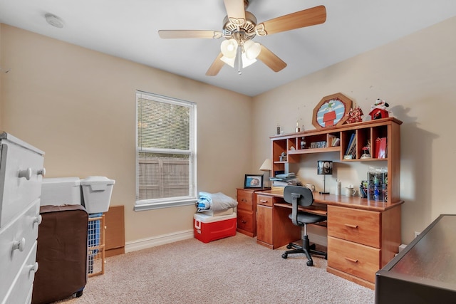 carpeted office featuring ceiling fan