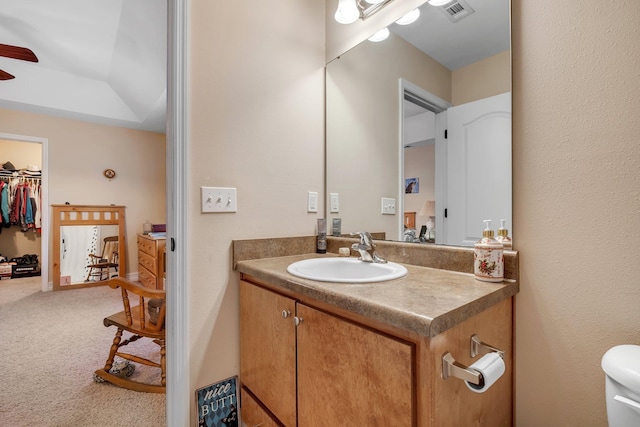 bathroom featuring vanity, ceiling fan, and toilet