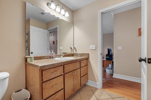 bathroom with vanity, tile patterned floors, and toilet