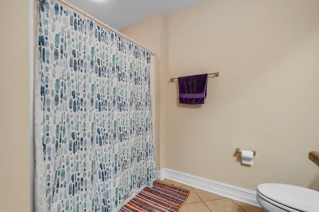 bathroom with tile patterned flooring and toilet