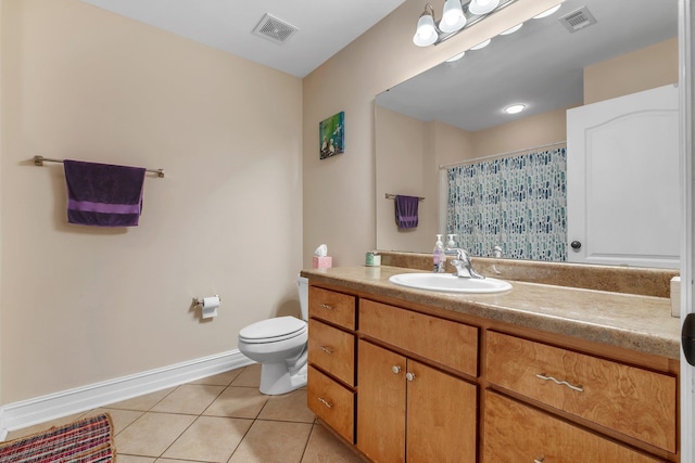 bathroom featuring walk in shower, vanity, toilet, and tile patterned flooring