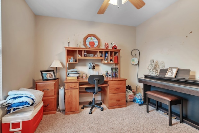 carpeted office space featuring ceiling fan