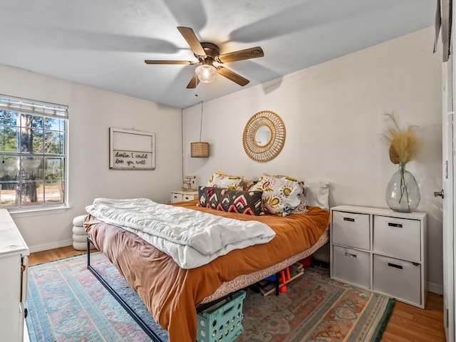 bedroom with hardwood / wood-style flooring and ceiling fan