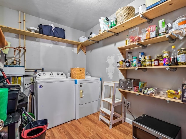 washroom featuring light hardwood / wood-style floors and washing machine and dryer