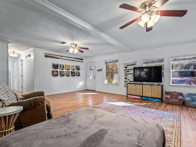 living room featuring hardwood / wood-style flooring, ceiling fan, and ornamental molding