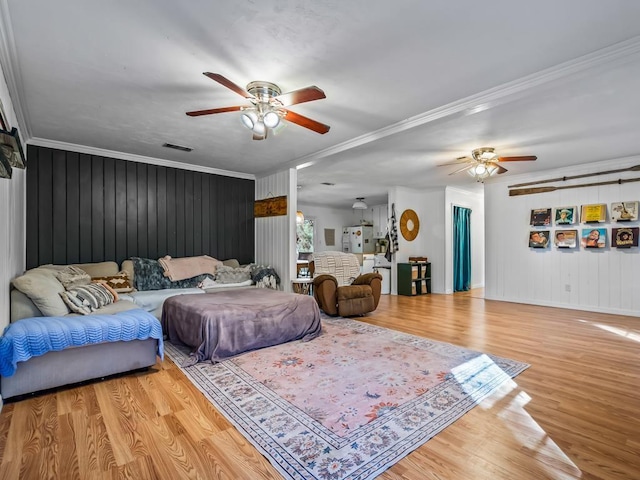 bedroom featuring crown molding, ceiling fan, and light wood-type flooring