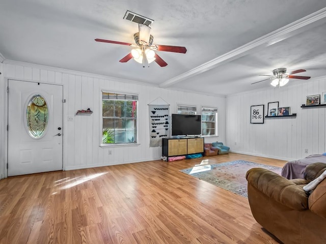 living room with light hardwood / wood-style flooring, ornamental molding, and ceiling fan