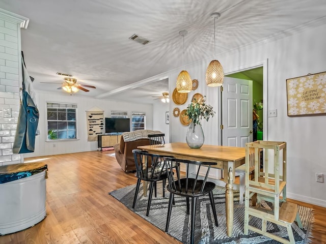 dining area featuring crown molding, hardwood / wood-style flooring, and ceiling fan