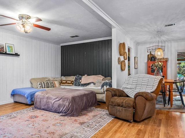 bedroom featuring crown molding, ceiling fan, and light hardwood / wood-style flooring