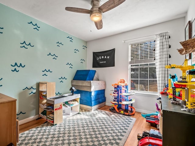 game room featuring hardwood / wood-style floors and ceiling fan