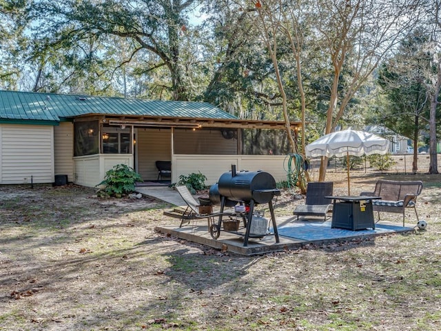 view of yard with a sunroom and a patio