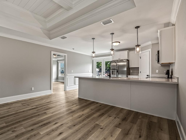 kitchen with white cabinetry, decorative light fixtures, ornamental molding, dark hardwood / wood-style flooring, and stainless steel appliances