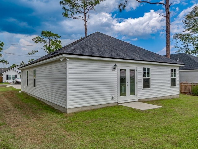 back of house featuring a lawn and french doors