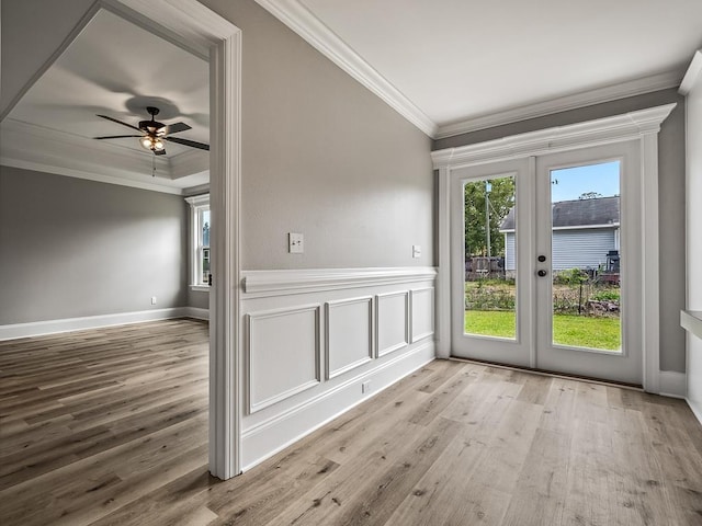 doorway to outside featuring crown molding, a wealth of natural light, ceiling fan, and light hardwood / wood-style flooring