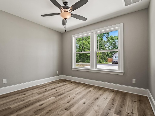 empty room with light hardwood / wood-style floors and ceiling fan