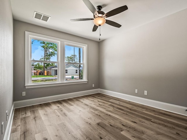 unfurnished room with ceiling fan and hardwood / wood-style floors