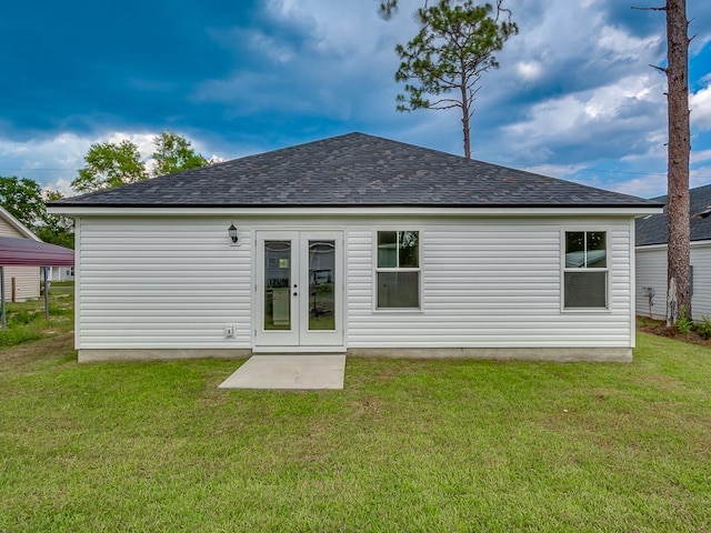 back of property with french doors and a yard