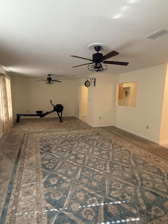 unfurnished room with visible vents, ceiling fan, a textured ceiling, and baseboards