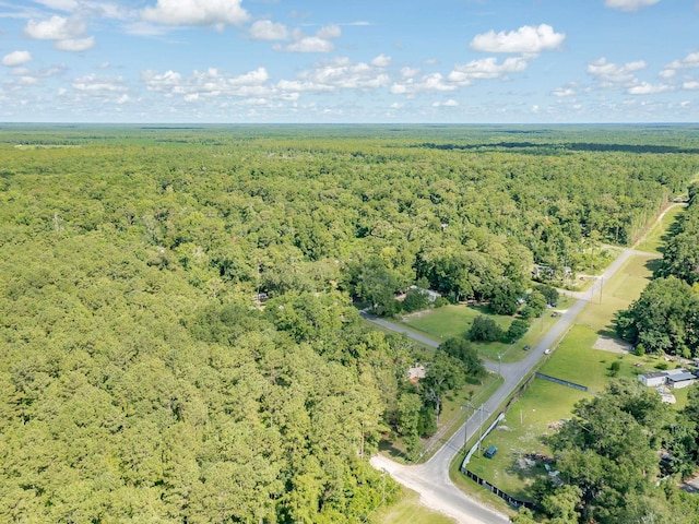 drone / aerial view featuring a forest view