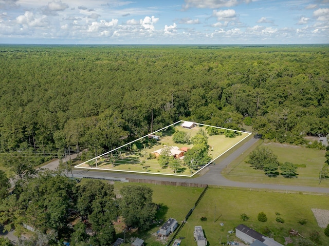 birds eye view of property featuring a view of trees