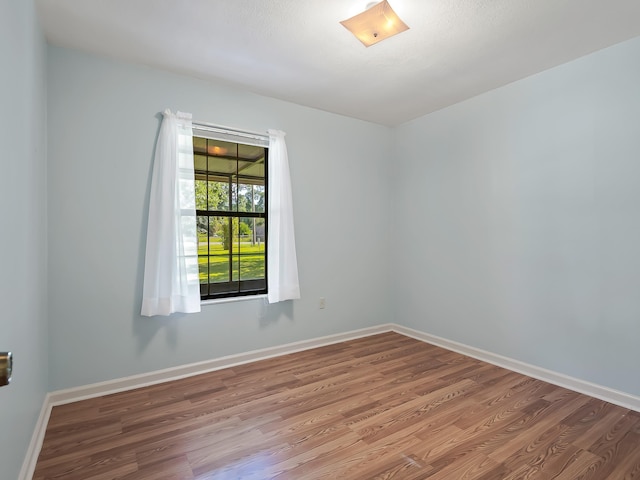 unfurnished room featuring light wood finished floors and baseboards