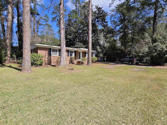 ranch-style home with brick siding and a front yard