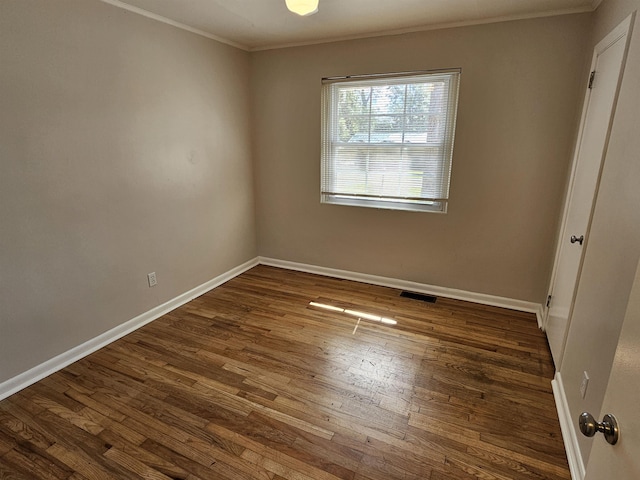 unfurnished bedroom featuring ornamental molding, dark wood finished floors, visible vents, and baseboards