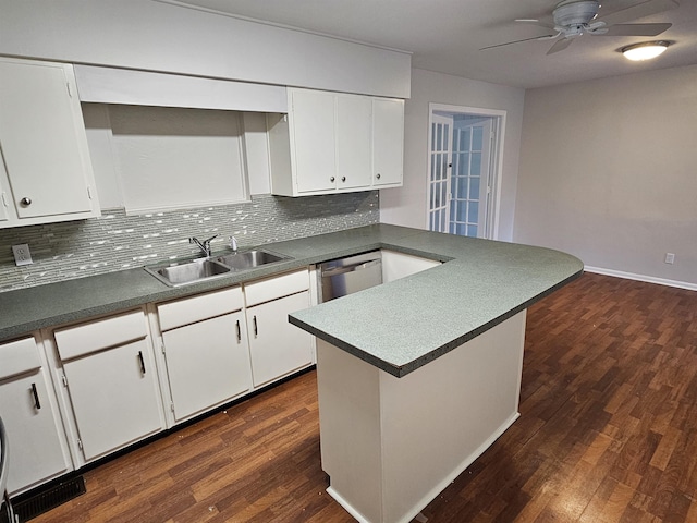 kitchen with a sink, white cabinetry, backsplash, dark wood-style floors, and dishwasher