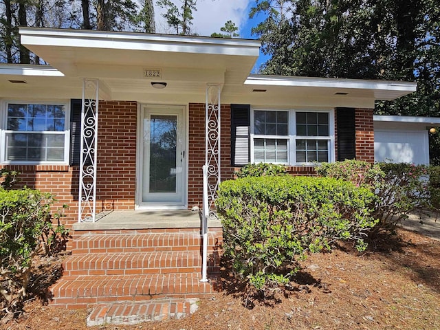 doorway to property with brick siding