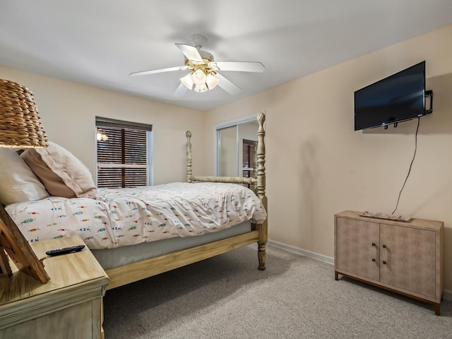 bedroom featuring ceiling fan, a closet, and light colored carpet