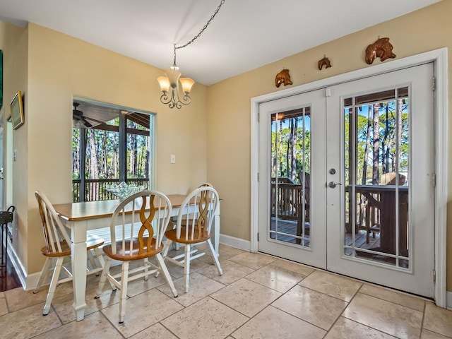 dining room featuring light tile patterned flooring, french doors, and an inviting chandelier