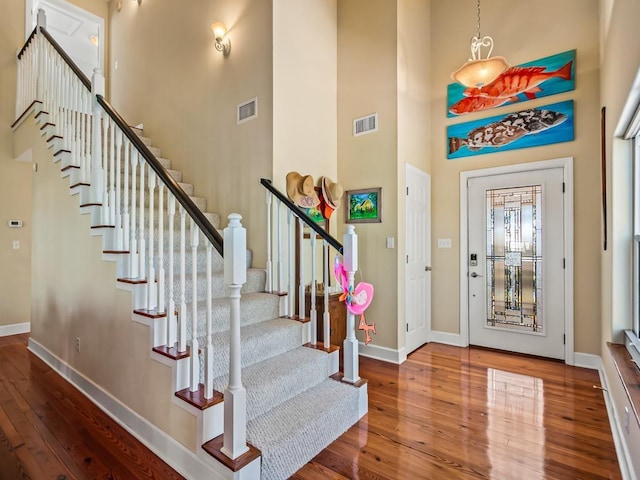 foyer featuring a high ceiling and wood-type flooring