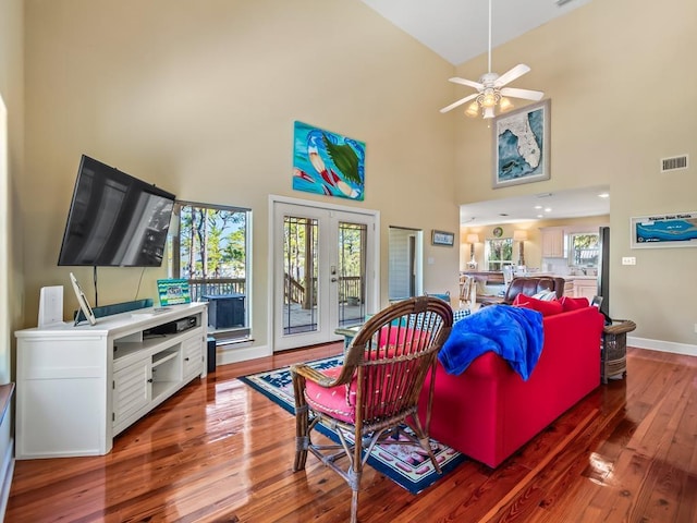 living room with hardwood / wood-style flooring, ceiling fan, a wealth of natural light, and french doors