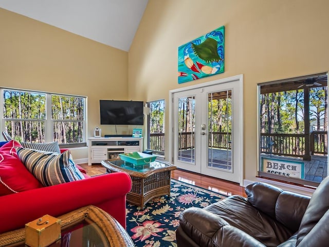 living room featuring ceiling fan, high vaulted ceiling, and french doors