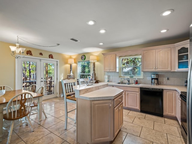 kitchen with french doors, tasteful backsplash, sink, black appliances, and a center island