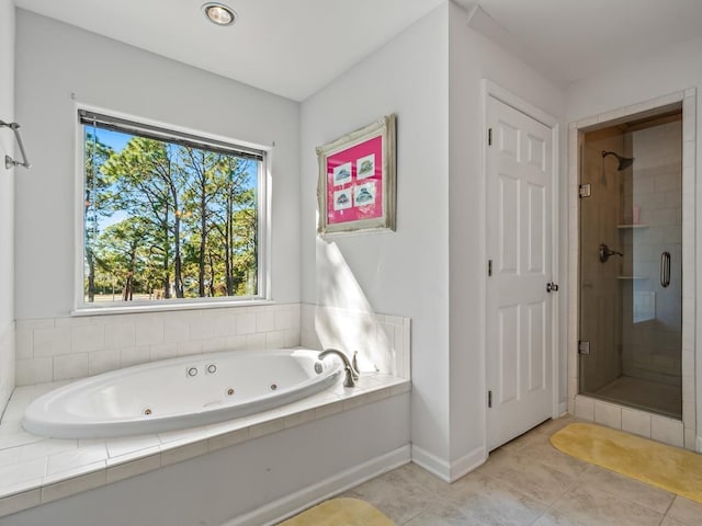 bathroom featuring tile patterned flooring and separate shower and tub