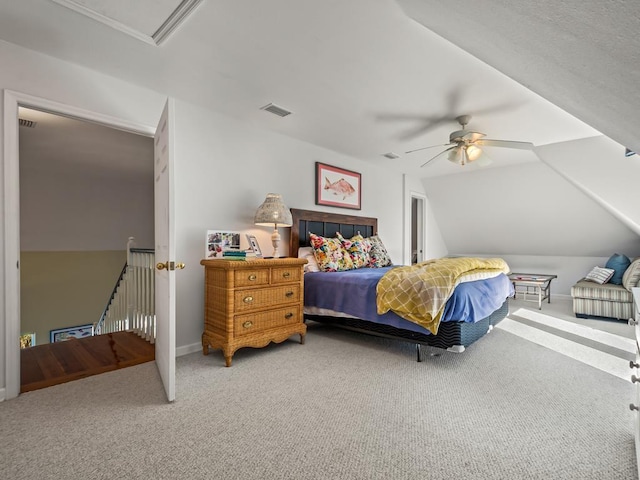 carpeted bedroom with ceiling fan and vaulted ceiling