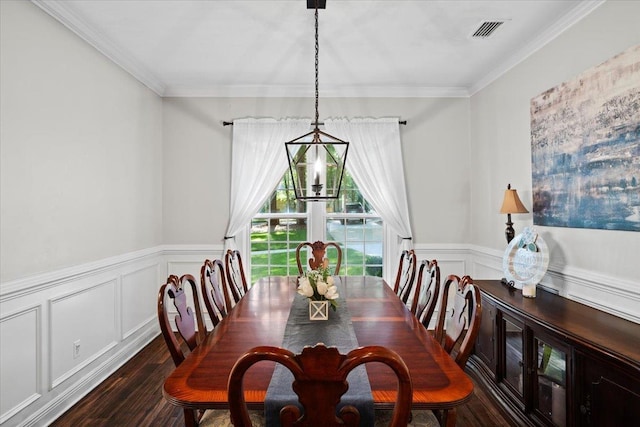 9816 Thunder Hill Trl, Tallahassee, FL 32312 - dining room featuring dark wood-type flooring, ornamental molding, a wainscoted wall, a chandelier, and a decorative wall