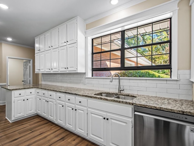 kitchen with dark wood-type flooring, stainless steel dishwasher, sink, and white cabinets