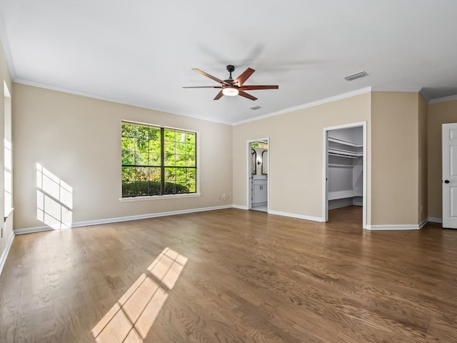 unfurnished living room with dark wood-type flooring, ceiling fan, and ornamental molding