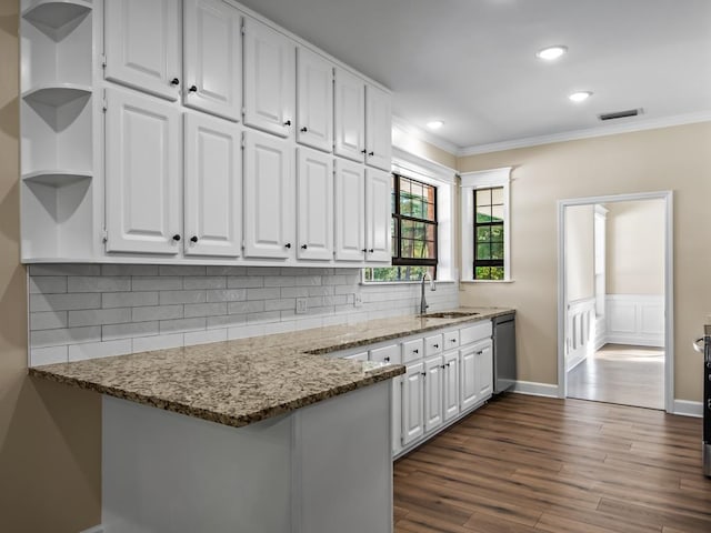 kitchen with dark hardwood / wood-style flooring, sink, crown molding, white cabinetry, and dark stone countertops